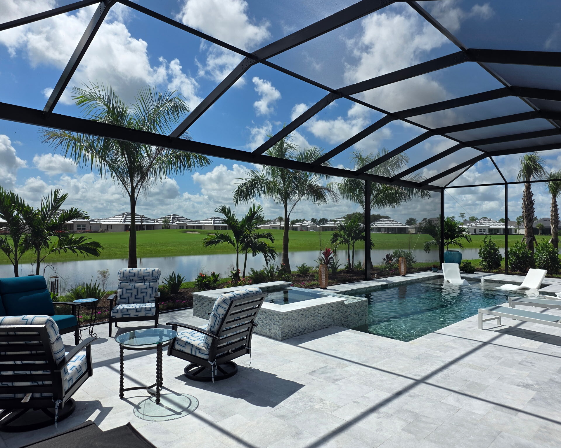 Raised spa, pool and deck seating with lake view in Babcock Ranch
